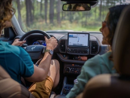 2024 Ford Bronco Sport interior view of 2 people in front seats traveling on road