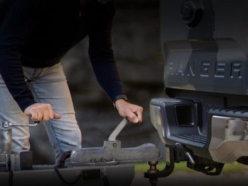 2024 Ford Ranger close up view of man attaching trailer to trailer hitch