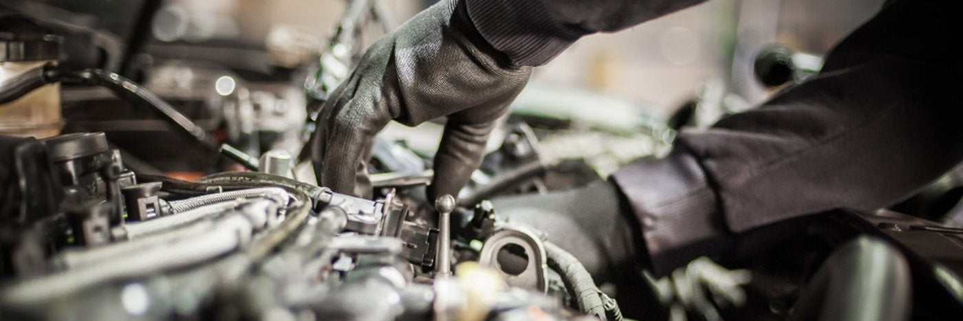 Close up view of a service tech working on an a/c compressor